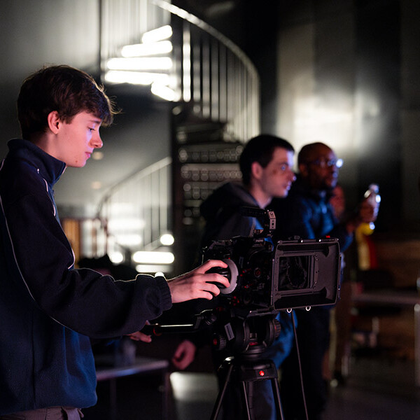 Student working camera in studio