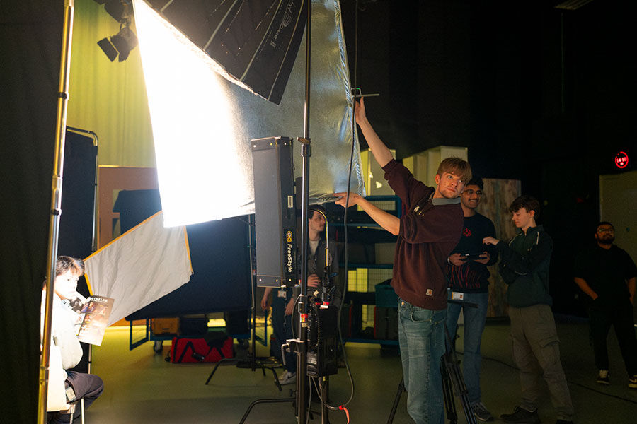 Students setting up lights in studio