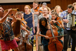 A lively, energetic group of musicians performing on stage