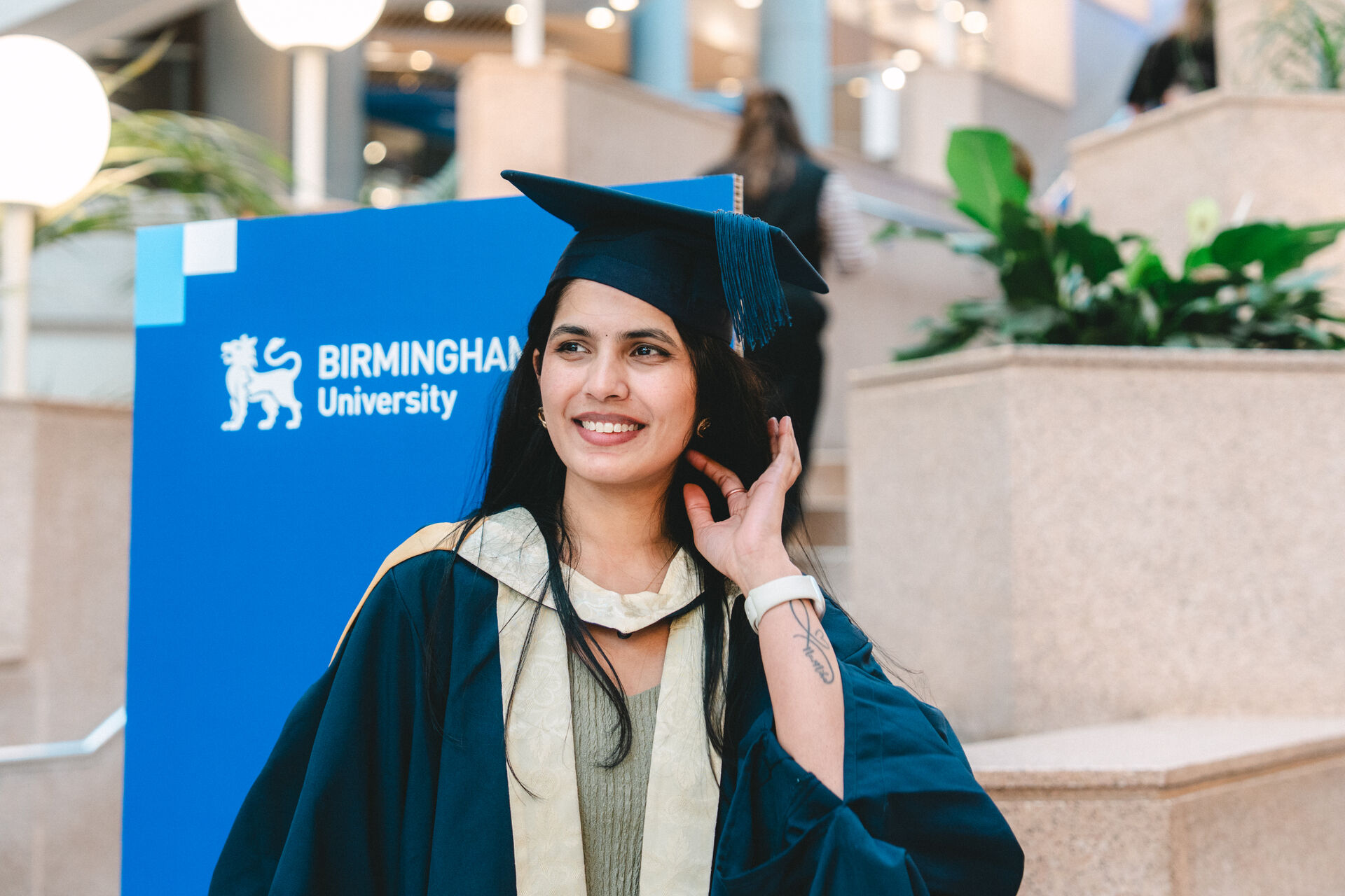 A BCU alumna poses for her picture at graduation wearing a graduation cap and gown