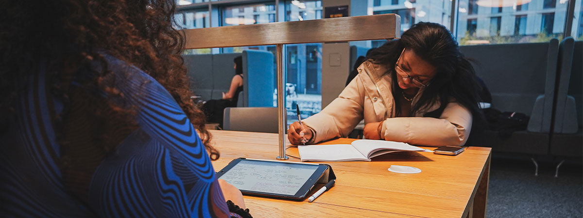 Two students studying at a desk