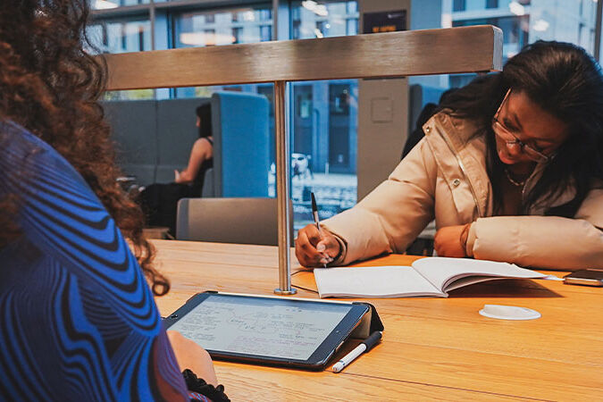 Two students studying at a desk