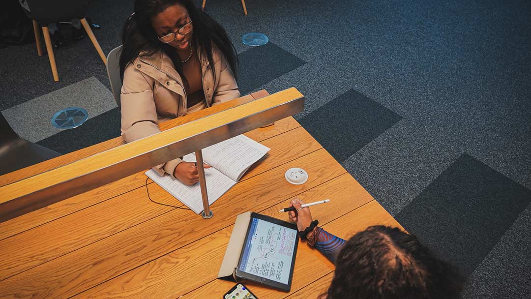 Two people studying at desk