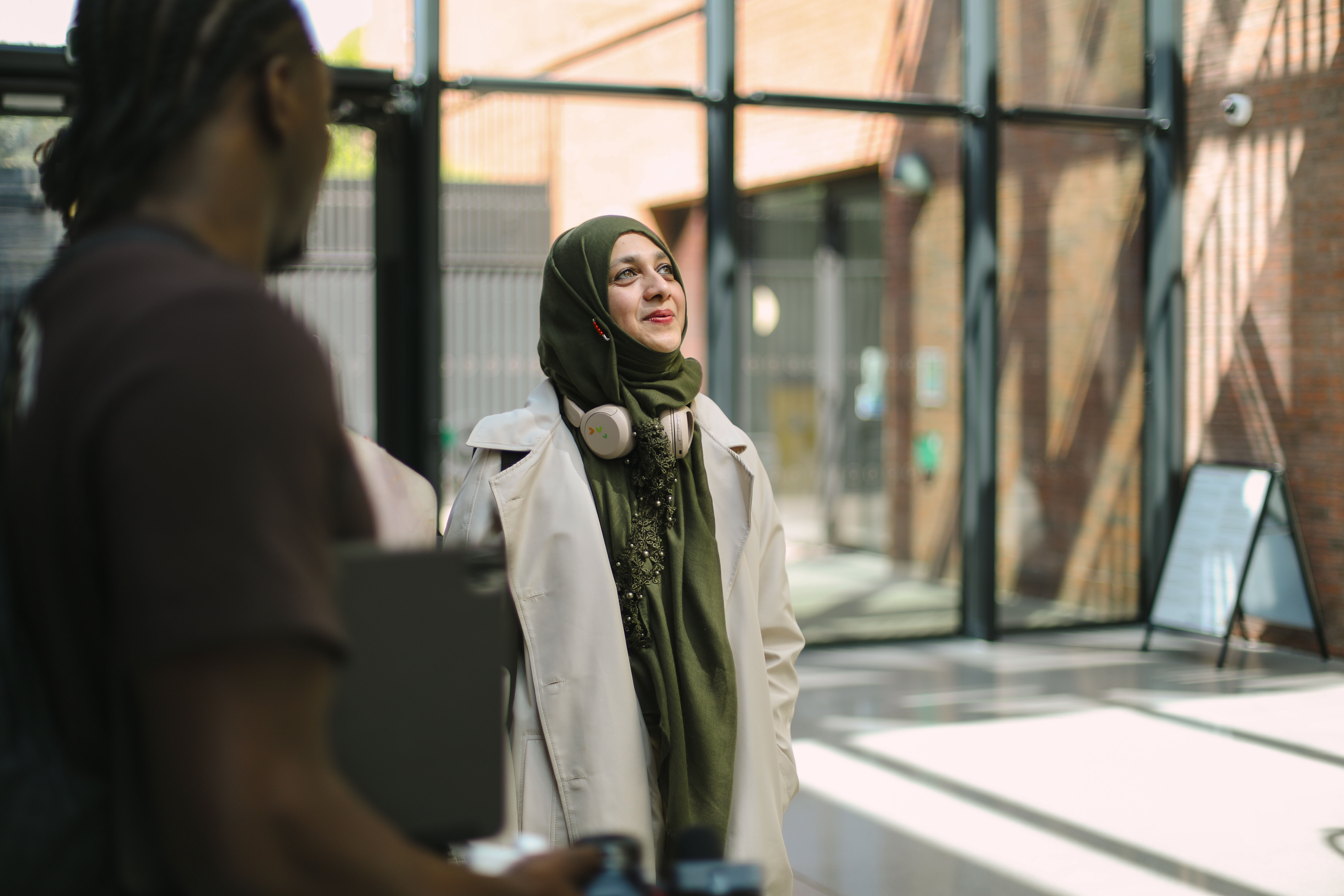 PhD Student looking upwards wearing headscarf