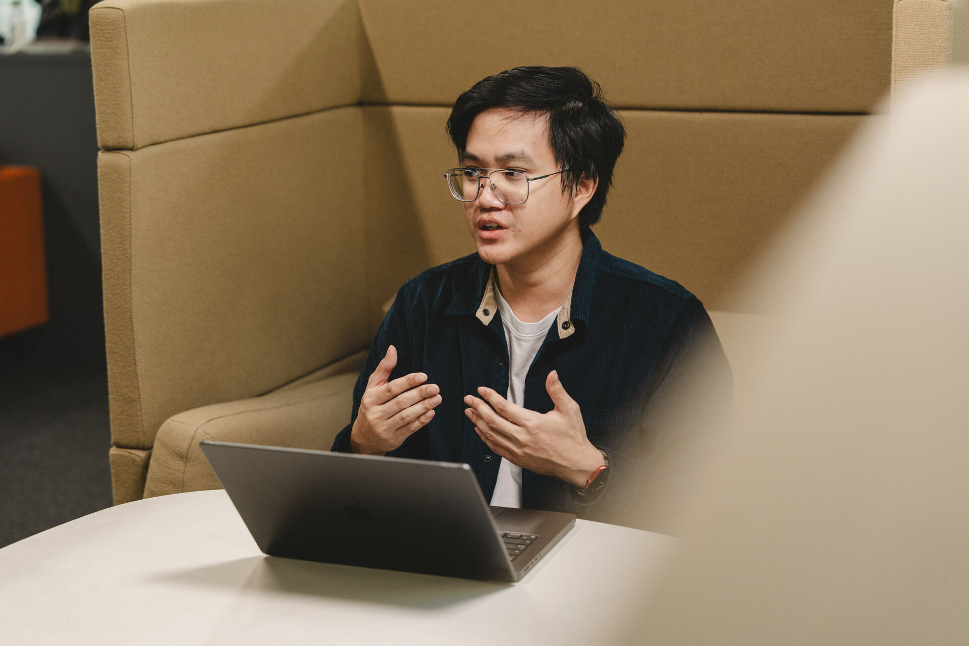 A Thai student who appears to be male speaking enthusiastically