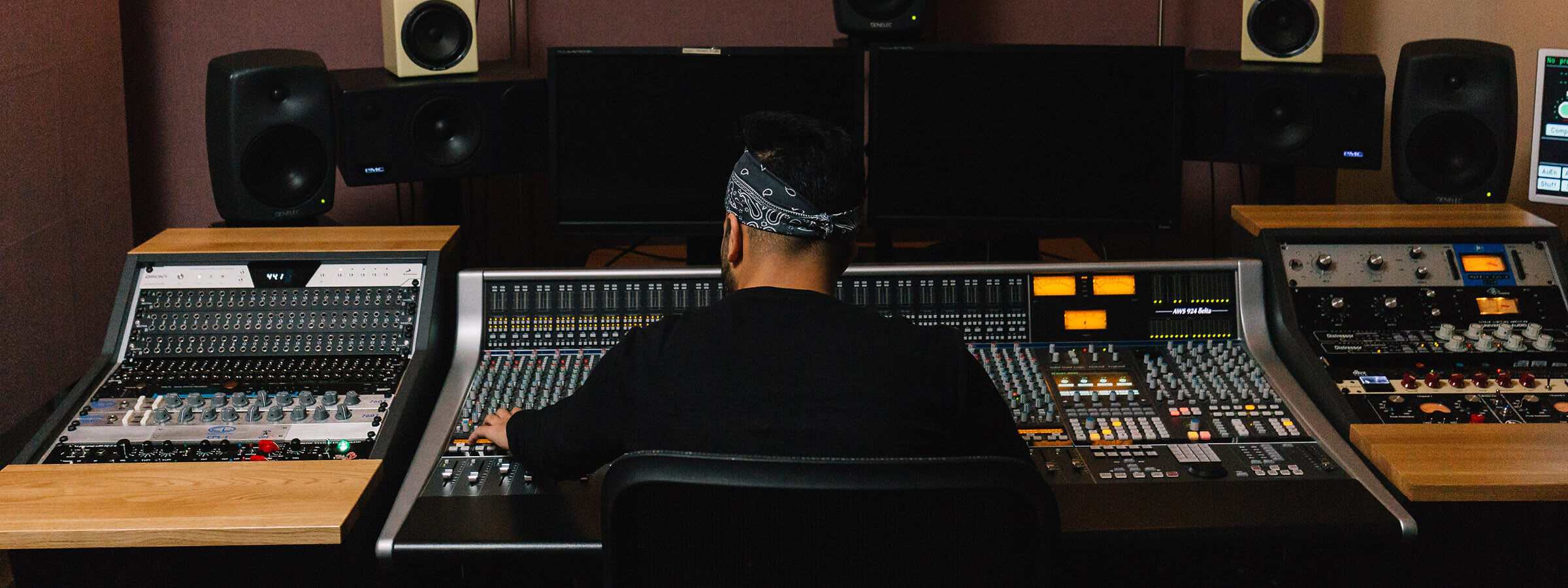 Student making music at a mixing desk