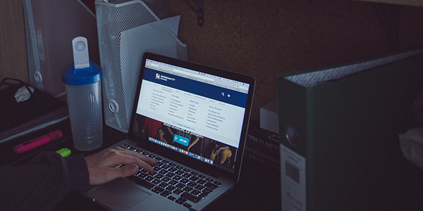 A person typing on a laptop