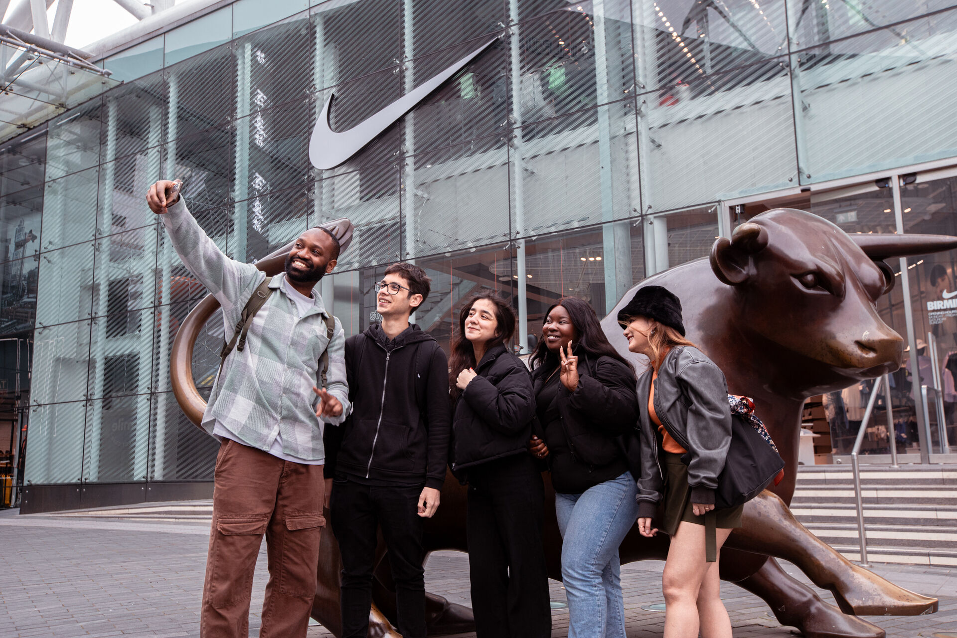 A group of students take a selfie in front of the Bull outside of the Bullring in Birmingham