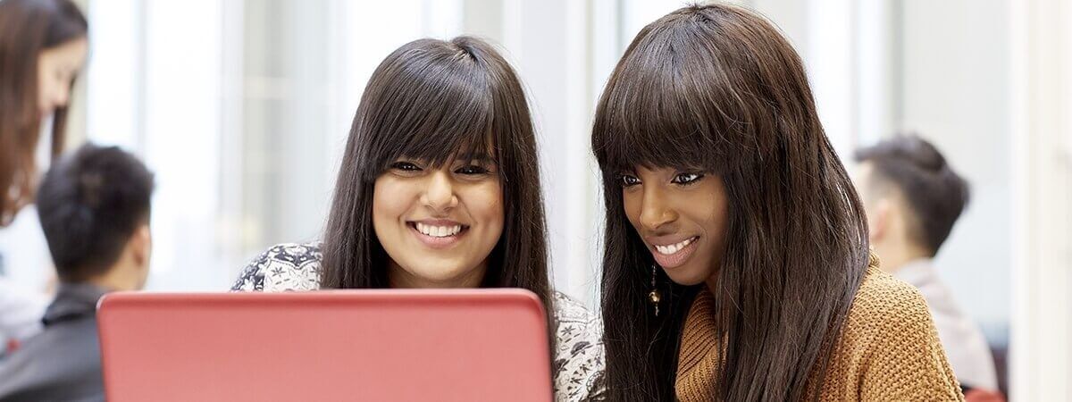 Two students working at a computer together