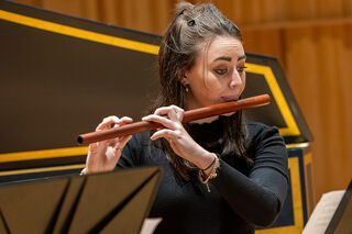Young woman playing renaissance flute
