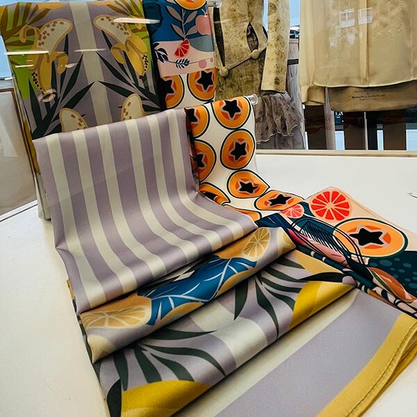 Rolls of patterned fabric with mannequins from MA Textile and Surface Design
