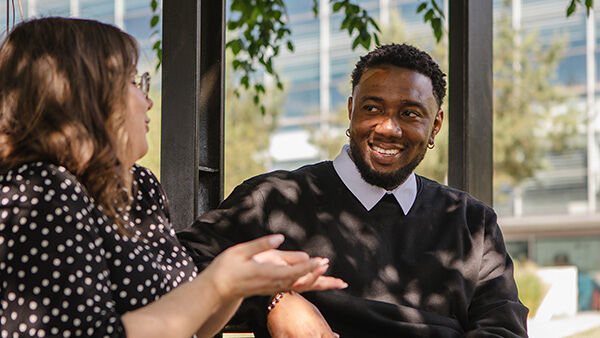 PGR student chatting outside