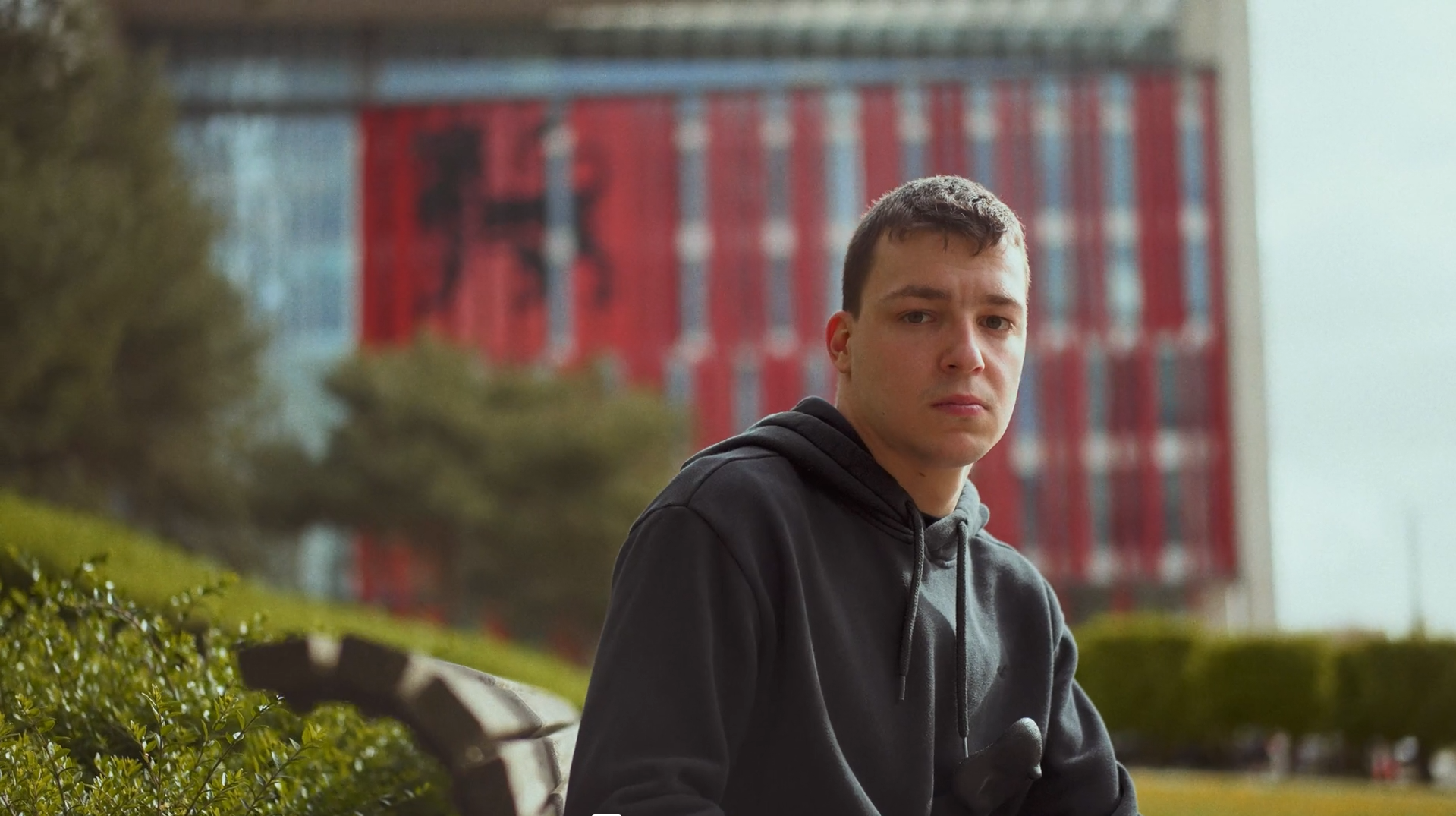 Student sat on bench looking into camera