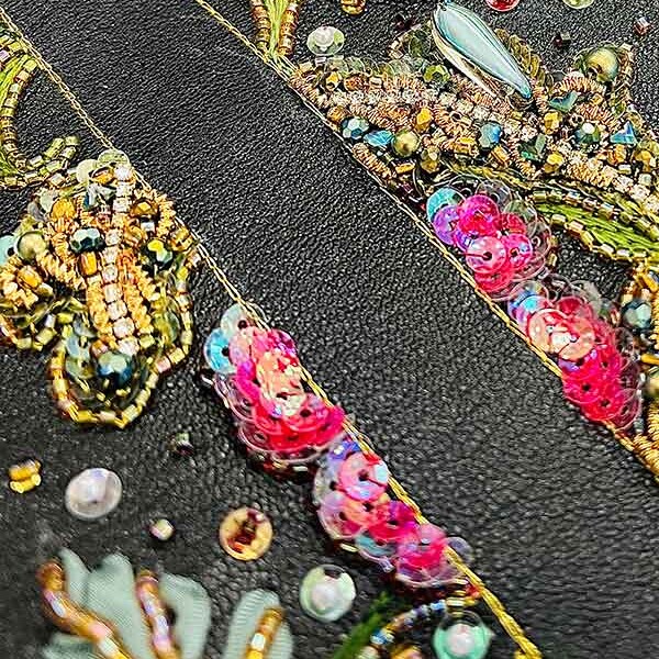 Sequins embroidered on black material from MA Textile and Surface Design