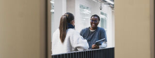 Two students standing and talking in STEAMhouse