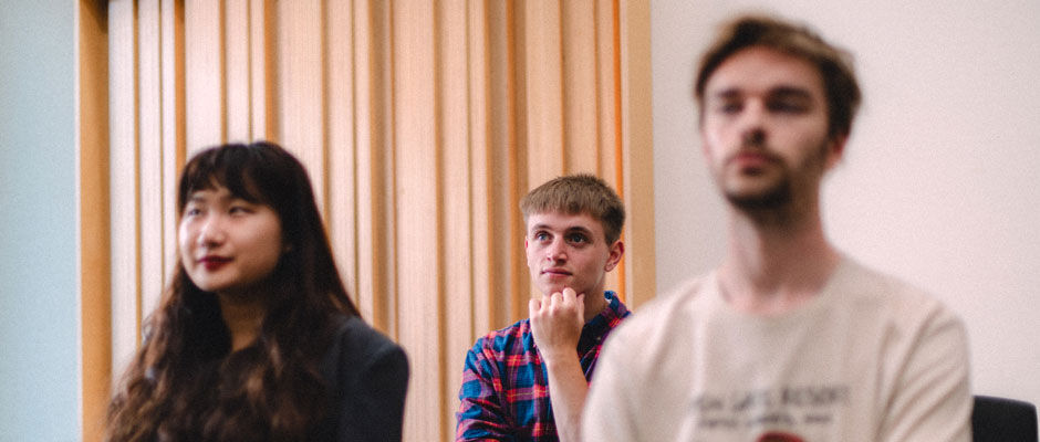 Three students in a lecture room