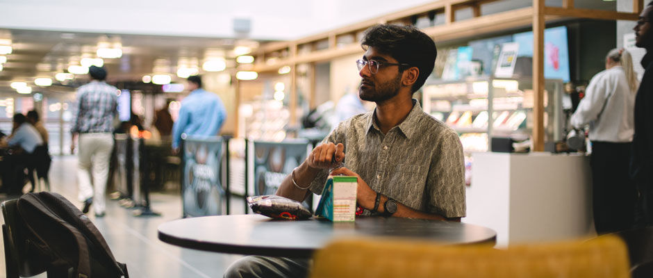 A student eats lunch in Curzon canteen
