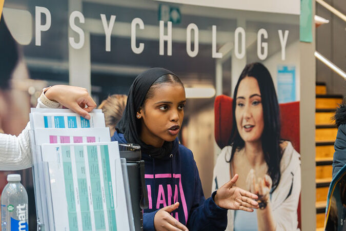 Student talking to visitor at an open day