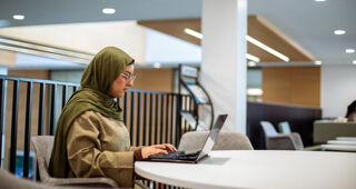 A student works on her laptop