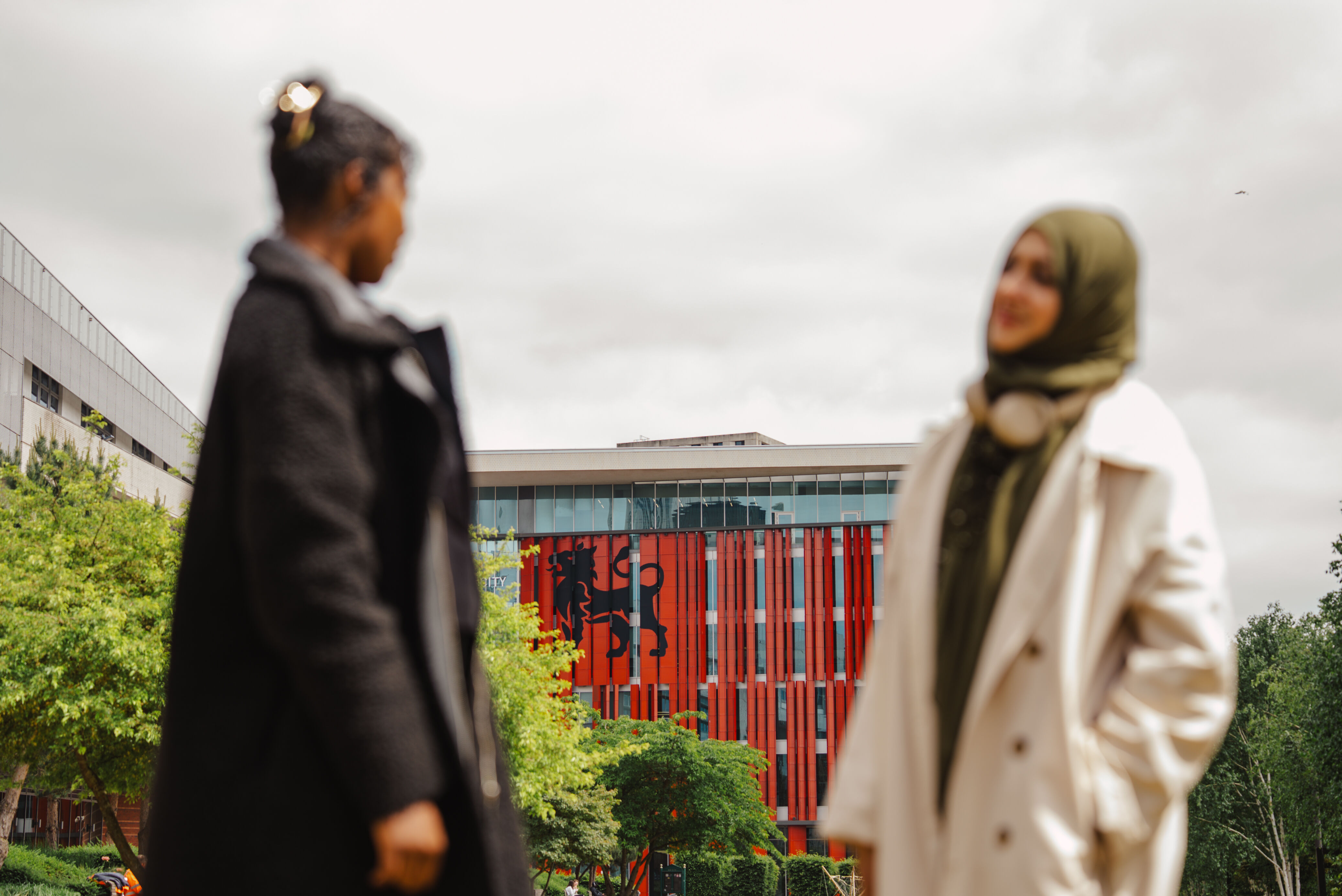 Two students by campus building