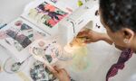 Student with sewing machine embroidering colourful circular patterns on light material