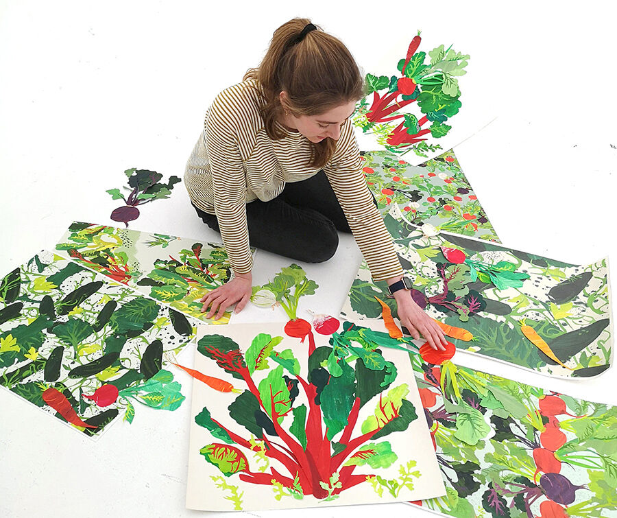 student sitting in the floor looking at paintings