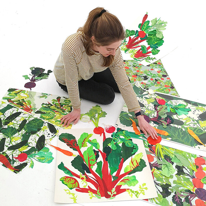 student sitting in the floor looking at paintings