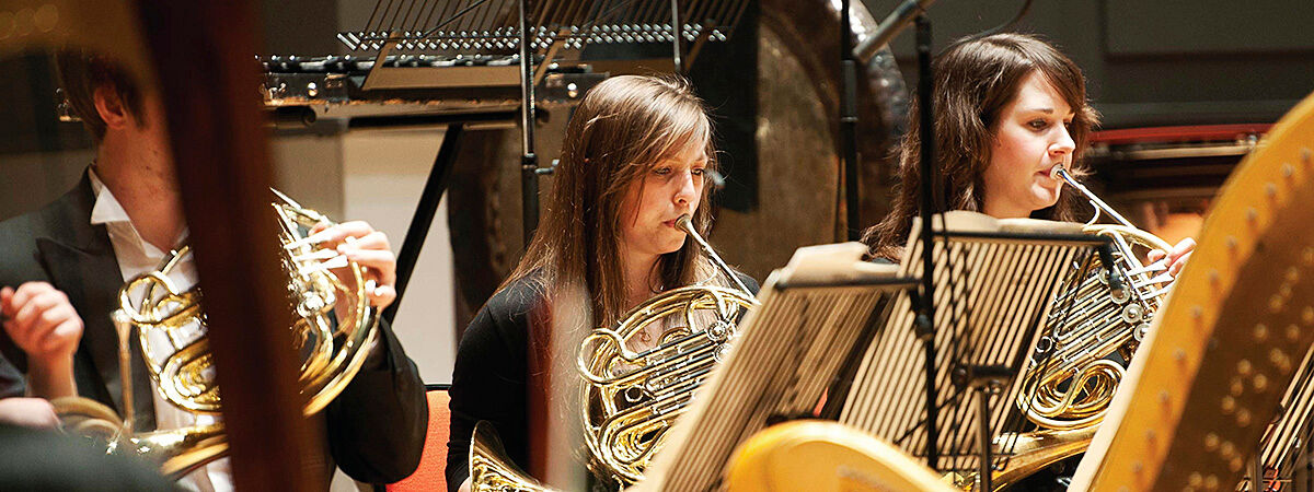 BCU Conservatoire student musicians playing the French horn.