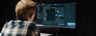 A PhD student using Unreal engine to develop a plugin on a computer screen