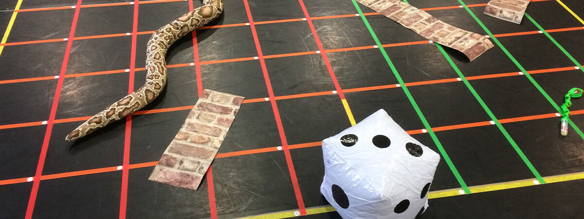 A board game artwork with dice and snakes and ladders