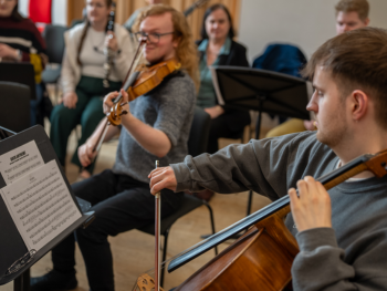 Two students playing a cello and violin at a rehearsal in RBC