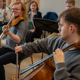Two students playing a cello and violin at a rehearsal in RBC