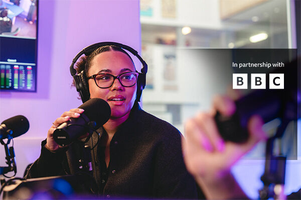 Student speaking into microphone in a radio studio