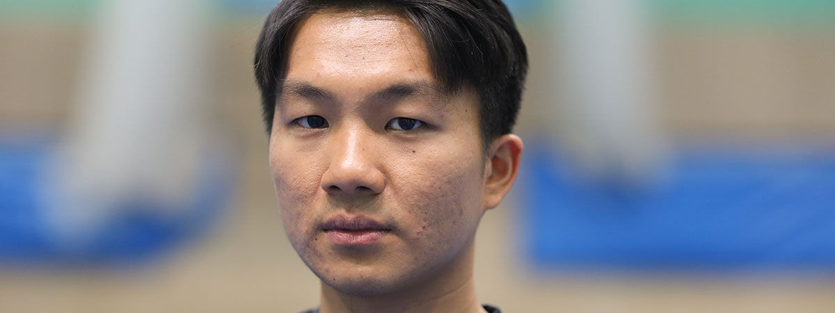 Wee Lun Foo looks down towards the camera