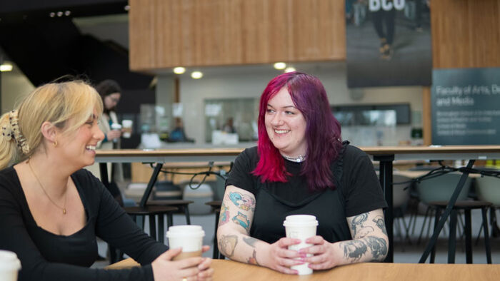 Two students talking over coffee