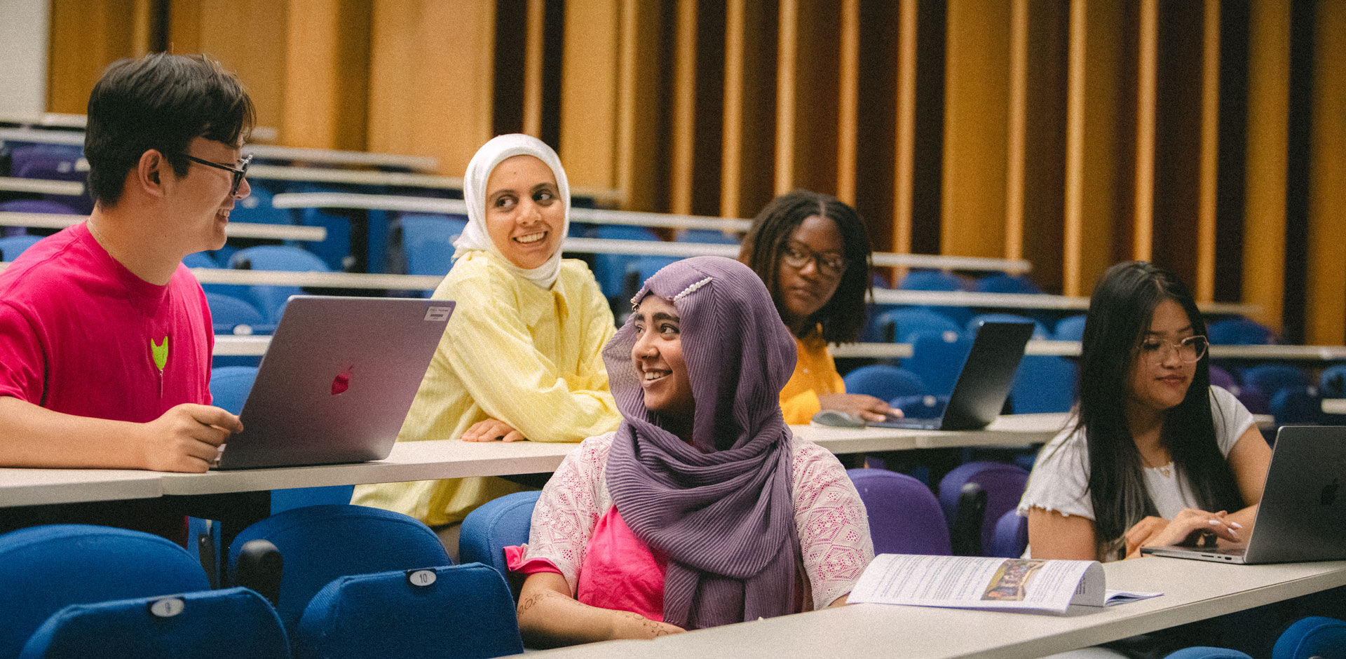 Students talking in a lecture theatre