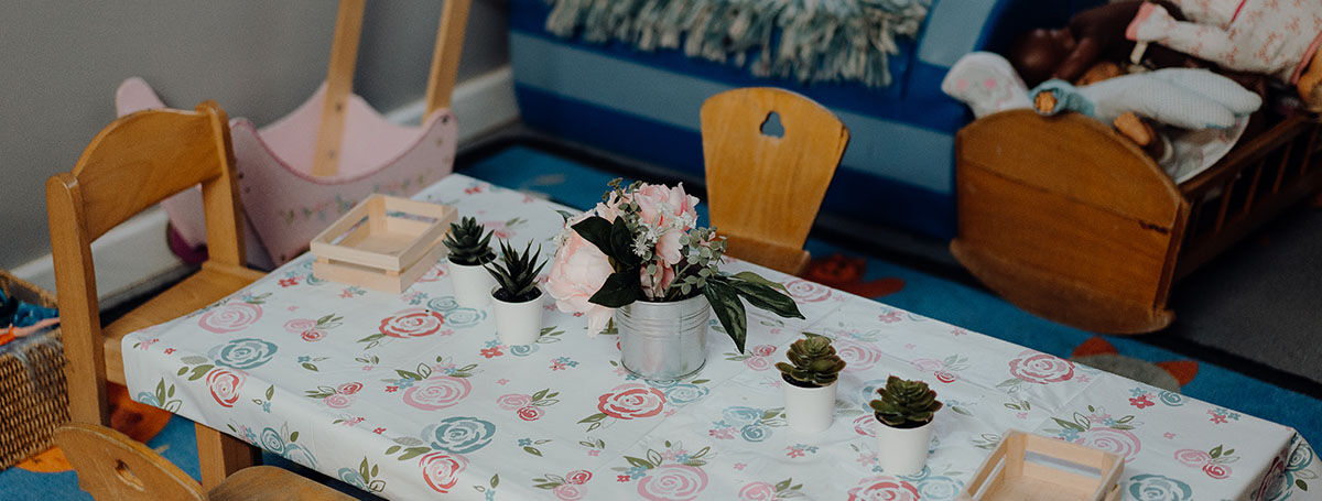 A table with floral arrangements on it, as part of the WSE family fun day.
