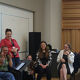 Youngsingers members in workshop sitting in a  group looking happy and laughing